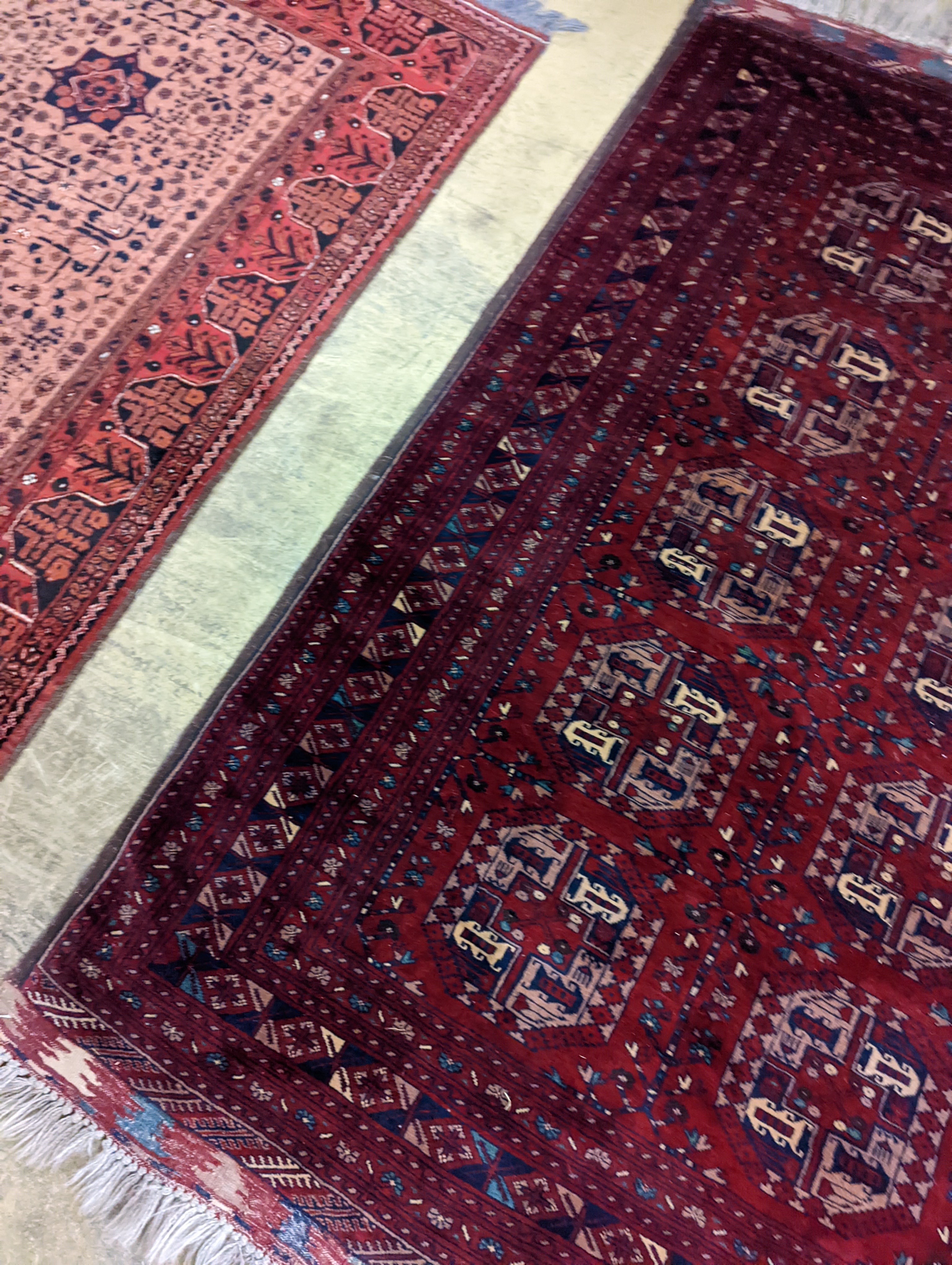A Belouch red ground rug woven with octagonal motifs, 190 x 124 cms.